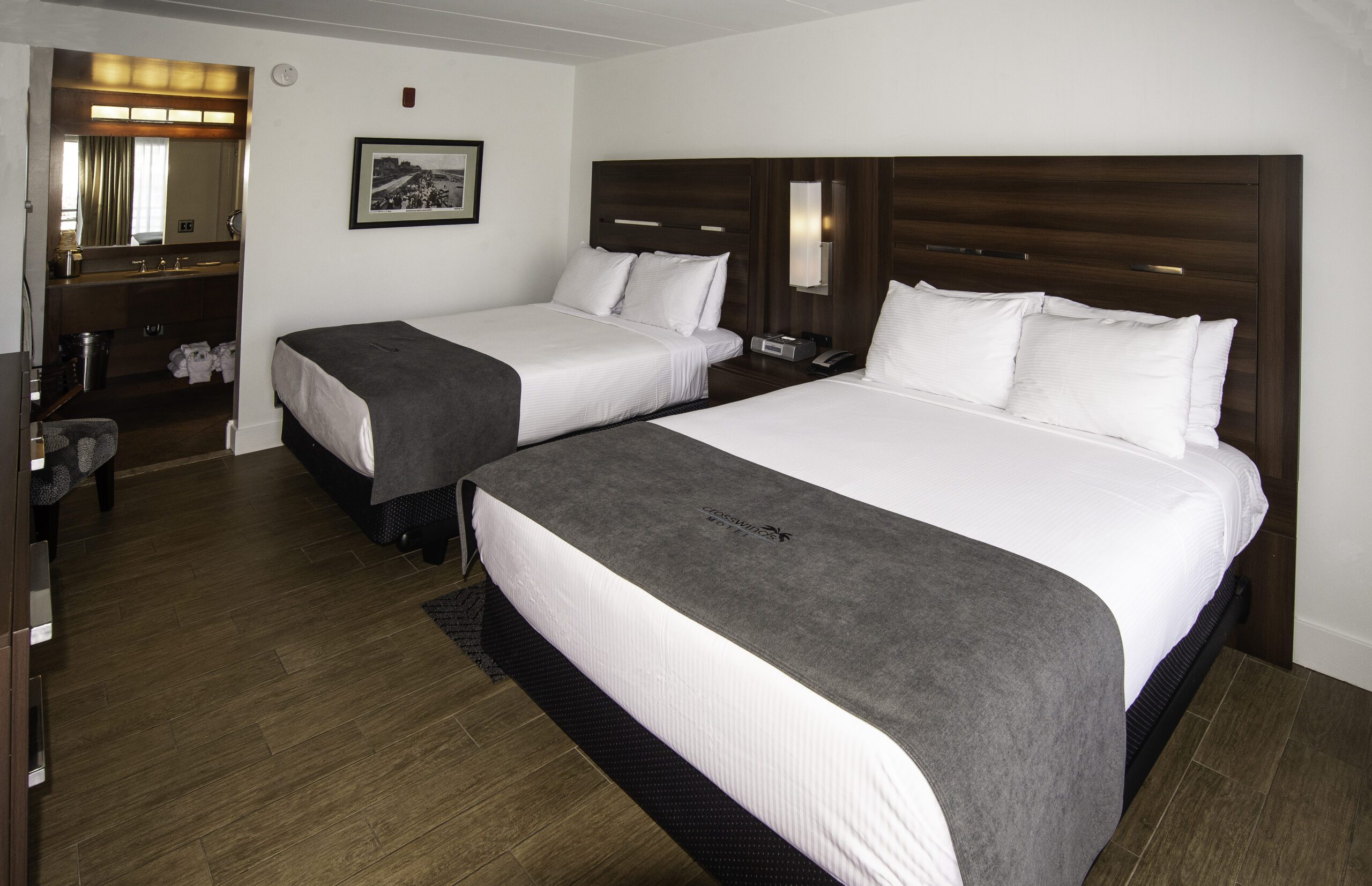 Two White Beds With Wooden Headboards